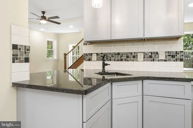 a kitchen with a sink and cabinets
