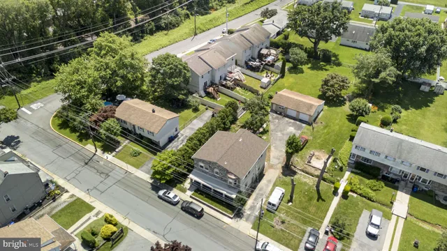 an aerial view of a house with a yard and outdoor seating