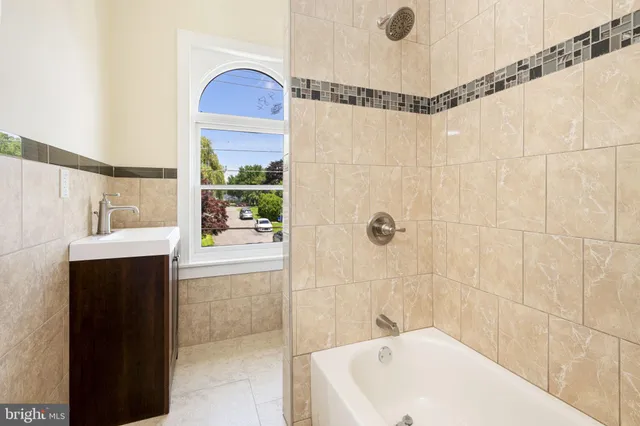 a bathroom with a sink a mirror and a bathtub