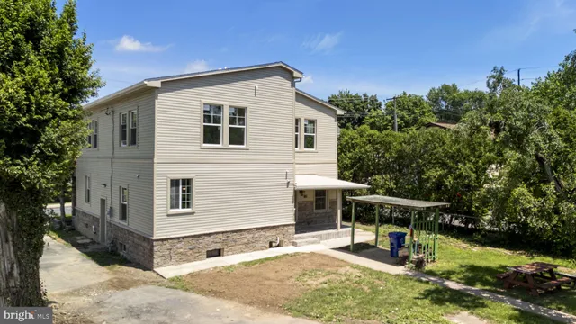 a view of a house with a yard and sitting area