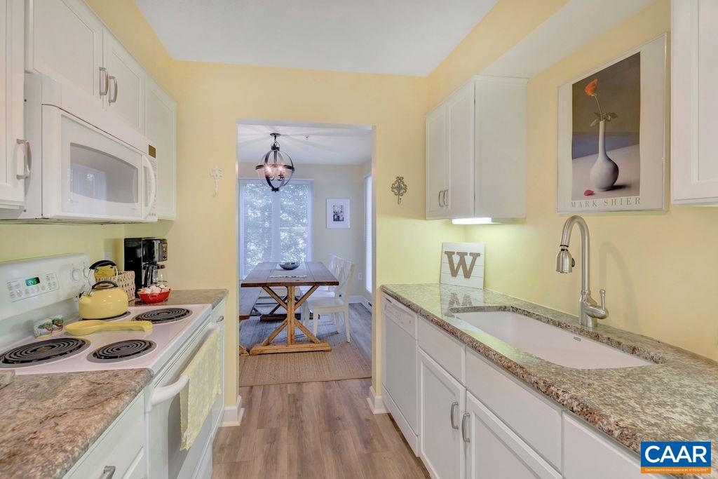2073 Stone Ridge Wintergreen, VA 22967 - Photo 8 of 33 a kitchen with granite countertop a sink stove and cabinets