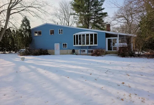 a view of a house with a yard covered in snow
