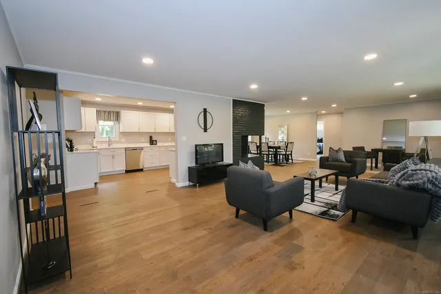 a living room with furniture and a kitchen view