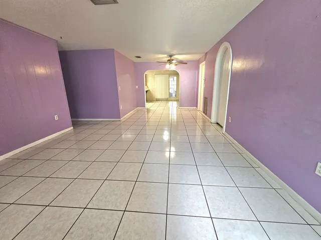 a tree in front of a white house
