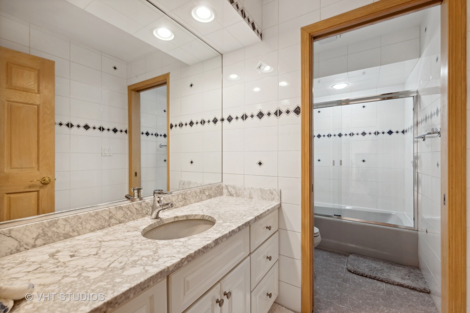 6705 Fieldstone Drive Burr Ridge, IL 60527 - Photo 22 of 41 a bathroom with a granite countertop sink mirror and shower