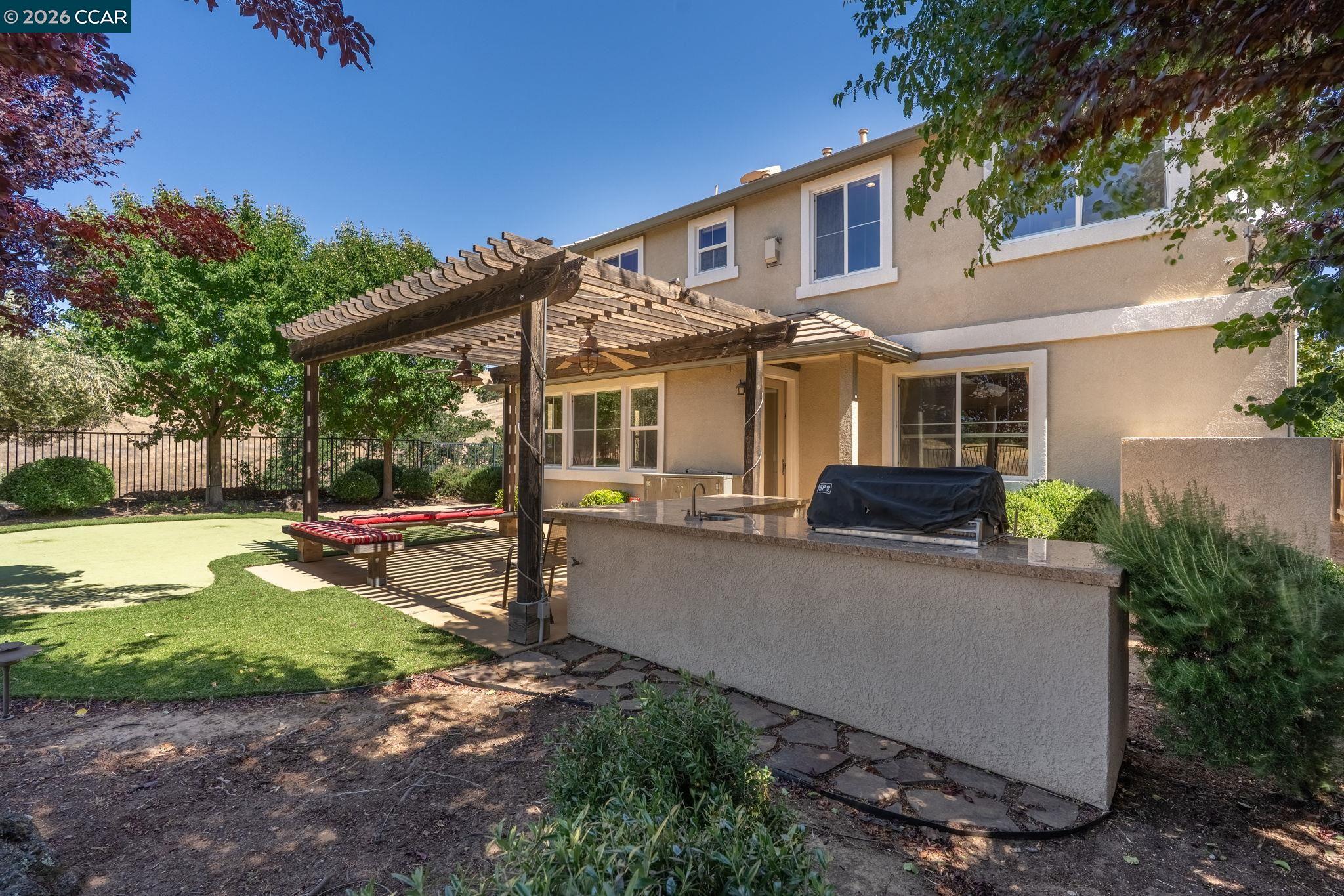 9028 Tee Court Patterson, CA 95363 - Photo 33 of 40 a view of a house with backyard and sitting area
