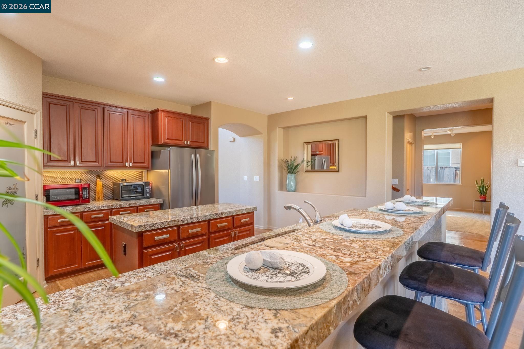9028 Tee Court Patterson, CA 95363 - Photo 6 of 40 a kitchen with a table and chairs in it