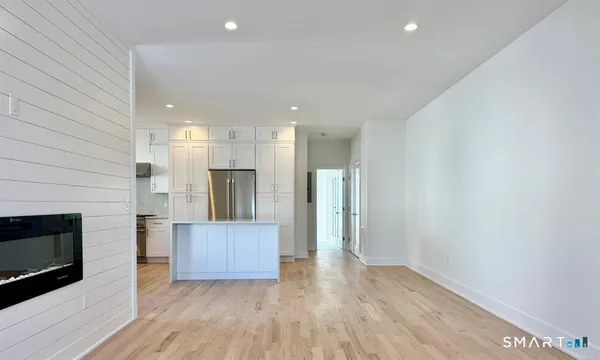a view of a kitchen with a sink and a fireplace