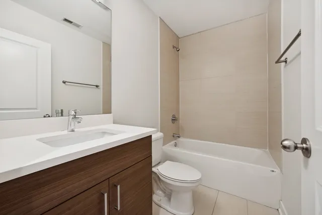 a bathroom with a sink a toilet a mirror and shower