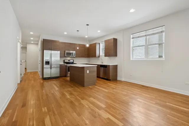 a view of kitchen with wooden floor and electronic appliances
