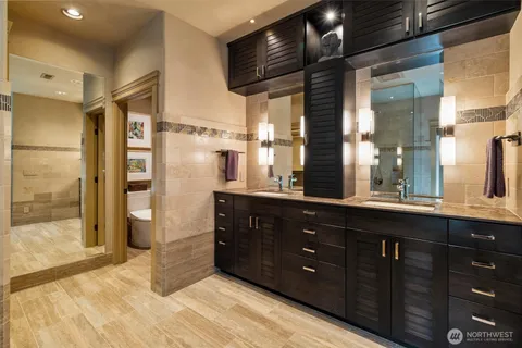 a bathroom with a tub shower and sink