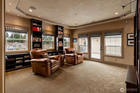 a living room with furniture a large window and a flat screen tv