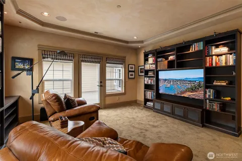 a living room with furniture a window and bookshelf