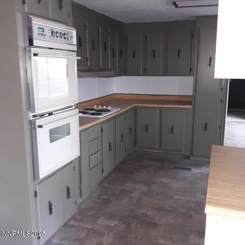 a kitchen with a refrigerator and a sink