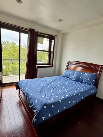 a bed sitting in a bedroom next to a window