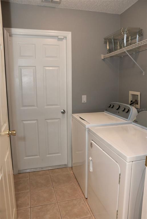 2807 Playing Otter Court Kissimmee, FL 34747 - Photo 12 of 25 a utility room with dryer and washer