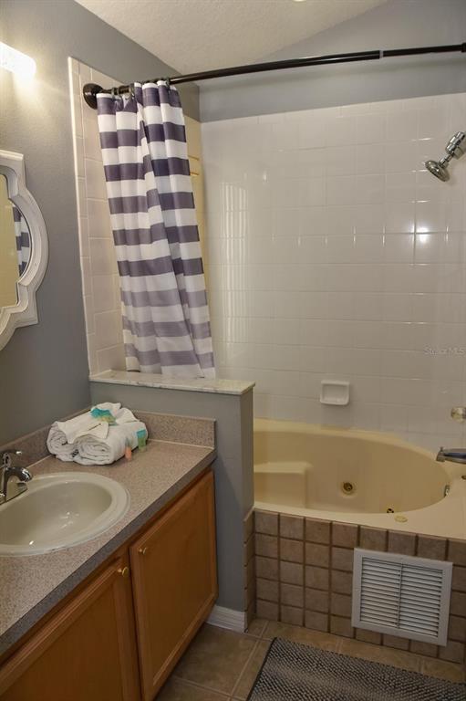 2807 Playing Otter Court Kissimmee, FL 34747 - Photo 14 of 25 a bathroom with a sink and a bathtub