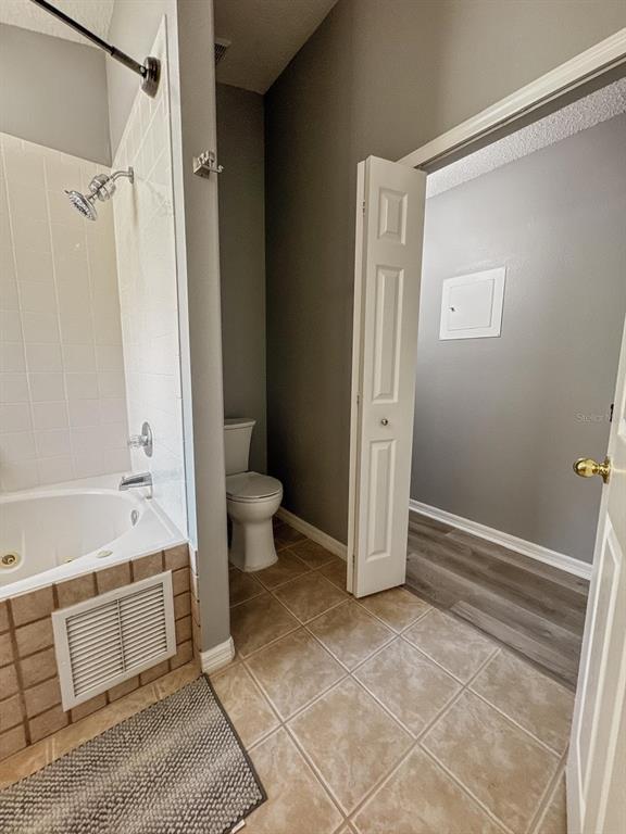 2807 Playing Otter Court Kissimmee, FL 34747 - Photo 15 of 25 a bathroom with a bathtub and a toilet