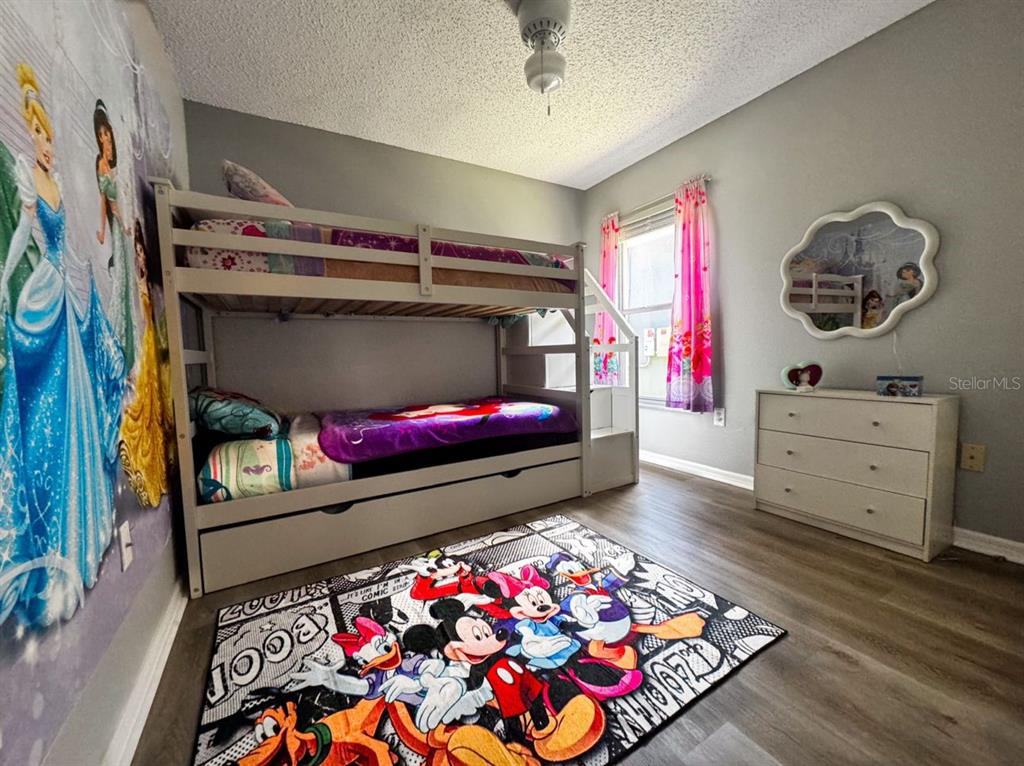 2807 Playing Otter Court Kissimmee, FL 34747 - Photo 17 of 25 a living room with furniture and a baby crib