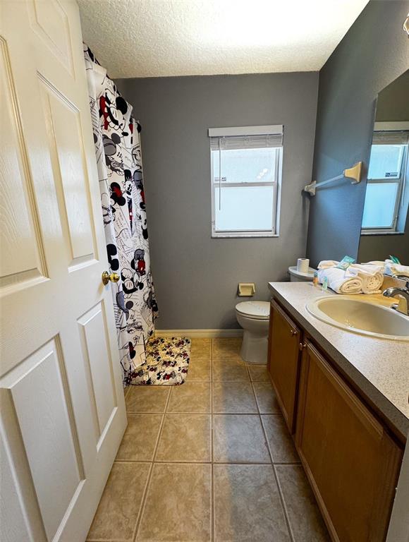 2807 Playing Otter Court Kissimmee, FL 34747 - Photo 18 of 25 a bathroom with a sink a toilet and shower