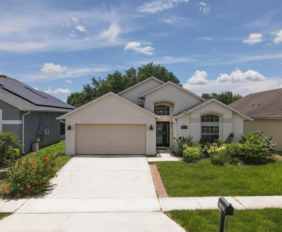 2807 Playing Otter Court Kissimmee, FL 34747 - Photo 2 of 25 a front view of a house with a yard and garage