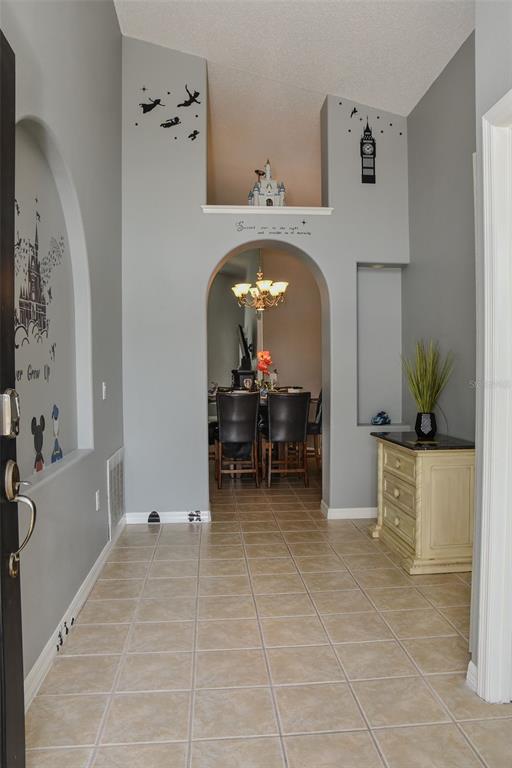 2807 Playing Otter Court Kissimmee, FL 34747 - Photo 3 of 25 a view of room with furniture and a chandelier