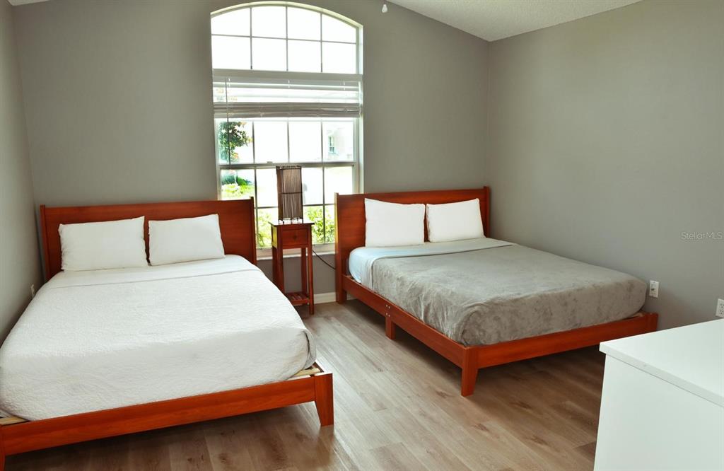 2807 Playing Otter Court Kissimmee, FL 34747 - Photo 5 of 25 a bedroom with a bed and window