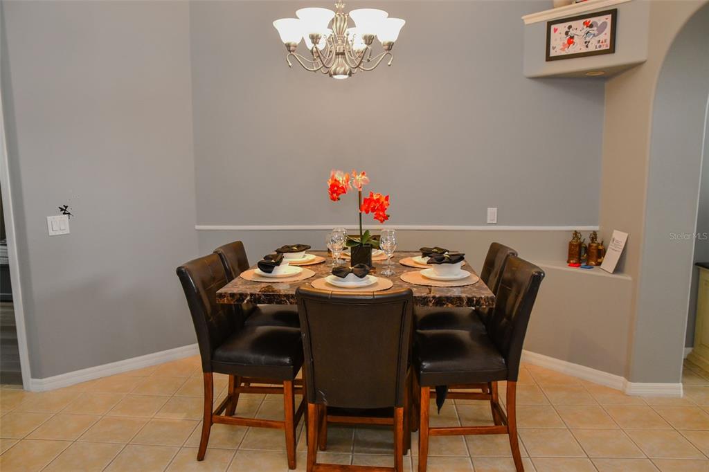 2807 Playing Otter Court Kissimmee, FL 34747 - Photo 7 of 25 a view of a dining room with furniture and a chandelier