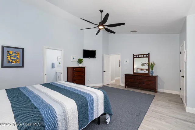 a bedroom with a bed and a chandelier