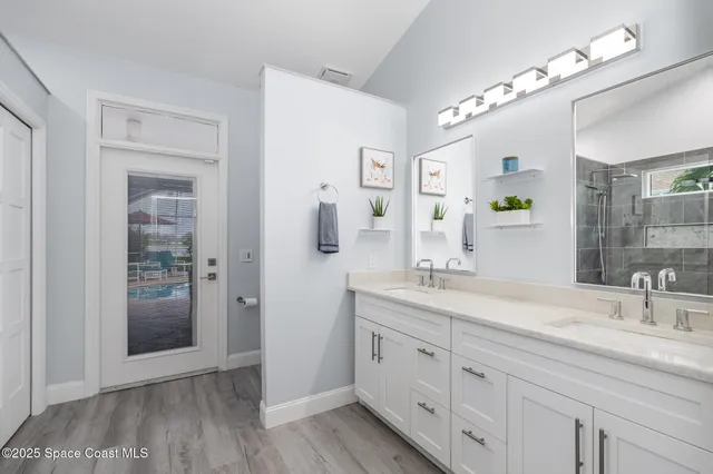 a spacious bathroom with a double vanity sink shower and a mirror