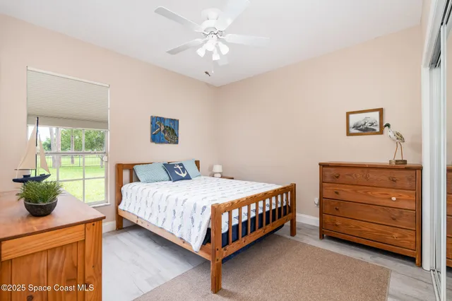 a bedroom with a bed dresser and a window