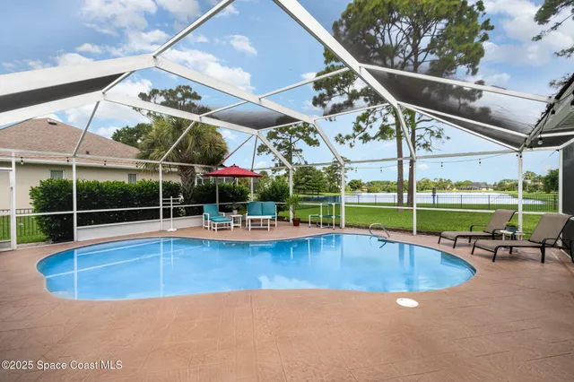 a view of a backyard with swimming pool
