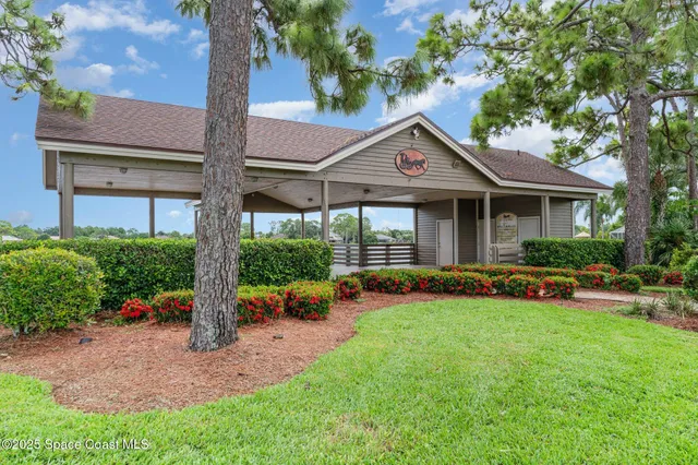 a front view of a house with a yard table and chairs