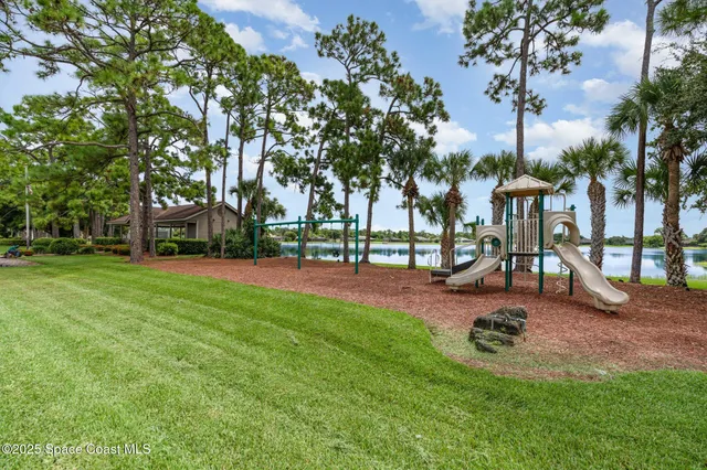 a view of outdoor space with playground and green space