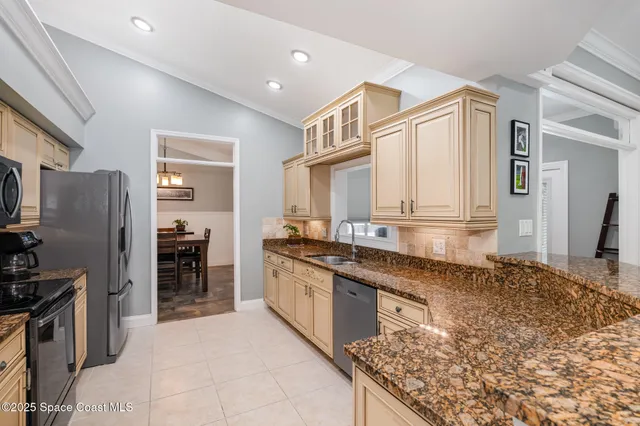 a kitchen with stainless steel appliances granite countertop a refrigerator and a stove top oven