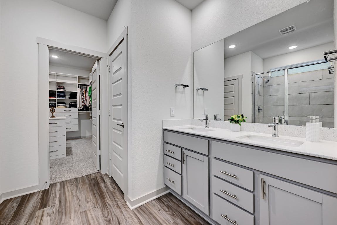7517 Peggie Nell Drive Austin, TX 78724 - Photo 13 of 37 a bathroom with a double vanity sink mirror and shower