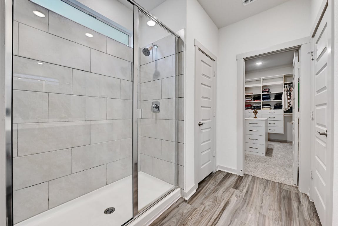 7517 Peggie Nell Drive Austin, TX 78724 - Photo 14 of 37 a bathroom with a shower and a glass door