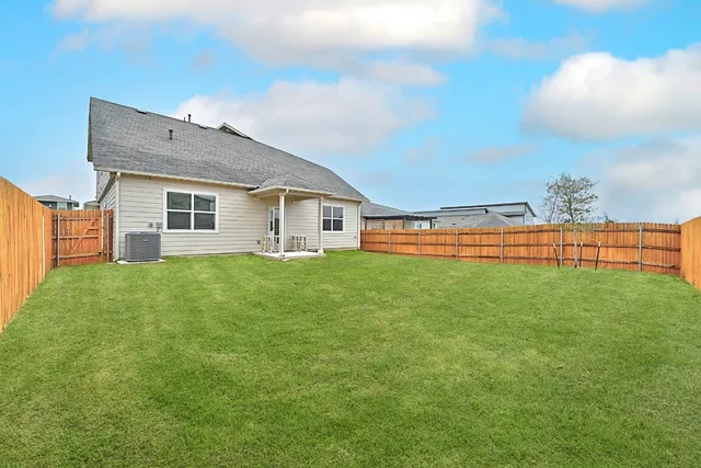 a view of a house with a yard and porch