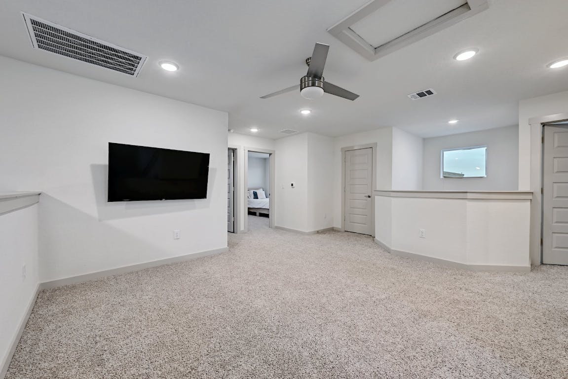 7517 Peggie Nell Drive Austin, TX 78724 - Photo 19 of 37 a view of an empty room with wooden floor and a window