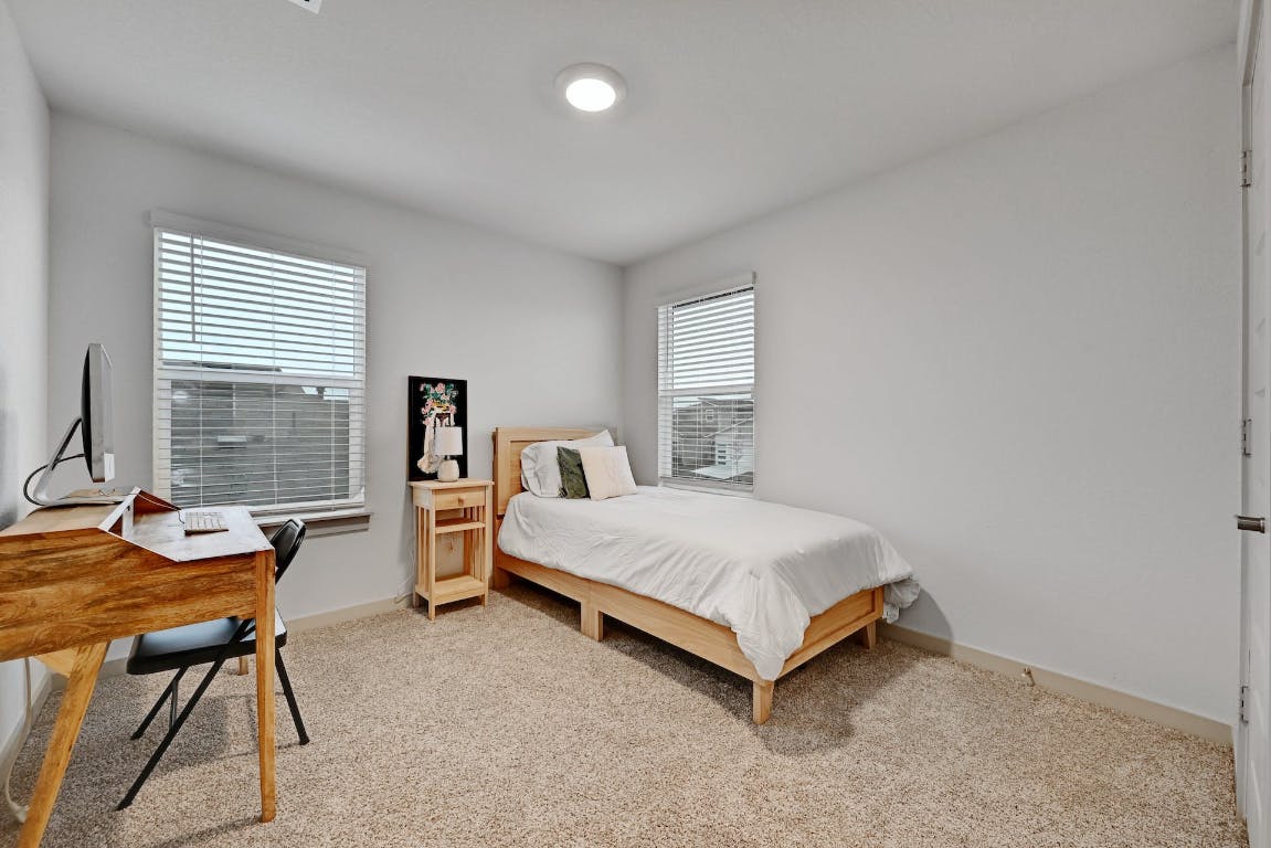 7517 Peggie Nell Drive Austin, TX 78724 - Photo 21 of 37 a bedroom with a bed and a desk