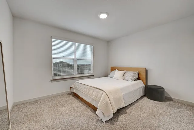 a bedroom with a bed and a desk