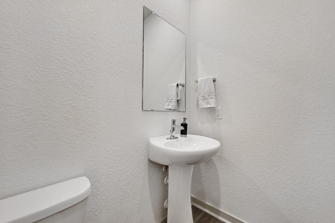 7517 Peggie Nell Drive Austin, TX 78724 - Photo 25 of 37 a bathroom with a sink a mirror and a toilet