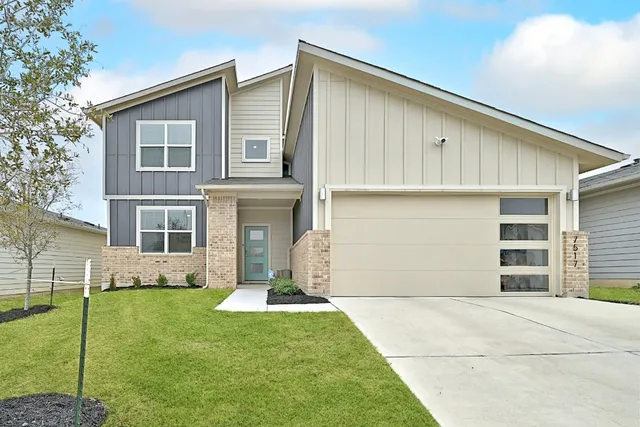 a front view of a house with a yard and porch
