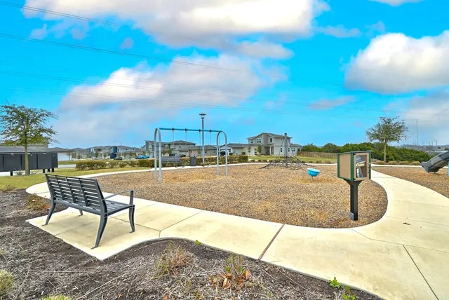 a view of a patio with a dining table and chairs under an umbrella