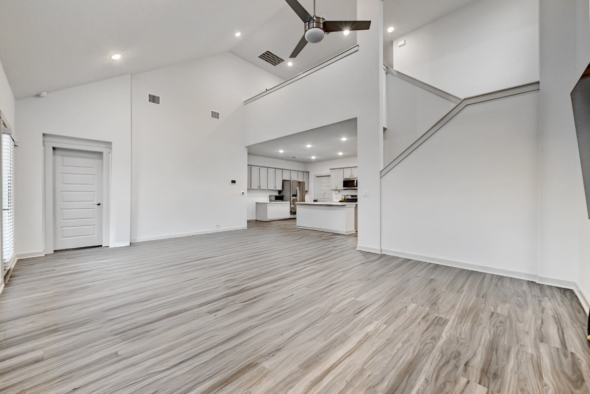 7517 Peggie Nell Drive Austin, TX 78724 - Photo 34 of 37 an empty room with wooden floor and a hallway