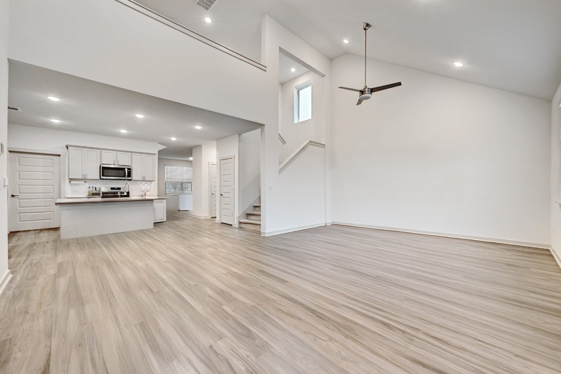 7517 Peggie Nell Drive Austin, TX 78724 - Photo 35 of 37 an empty room with wooden floor kitchen view and windows