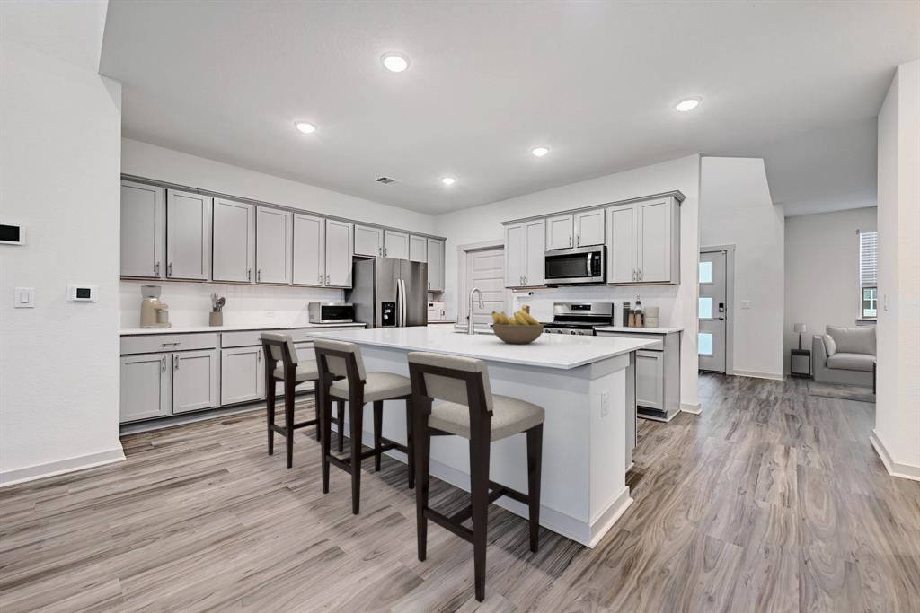 7517 Peggie Nell Drive Austin, TX 78724 - Photo 5 of 37 a kitchen with a sink a counter top space stainless steel appliances and cabinets