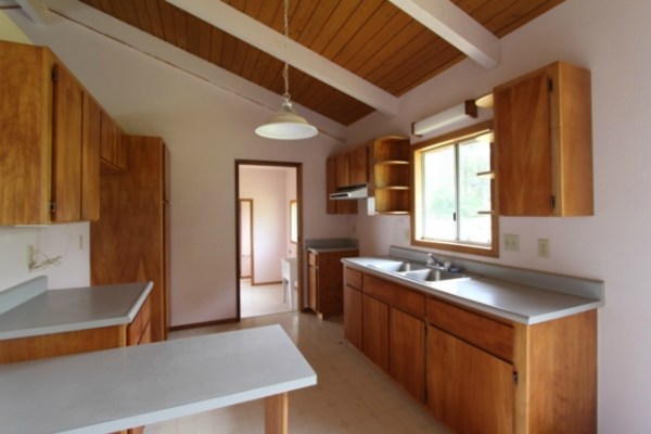 18-7844 Kolika Road Mountain View, HI 96771 - Photo 3 of 10 a kitchen that has a sink a stove and a refrigerator