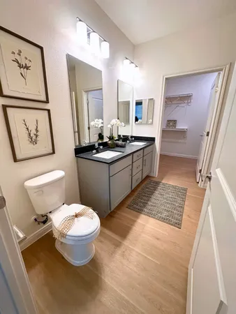 a kitchen with a sink stove and white cabinets