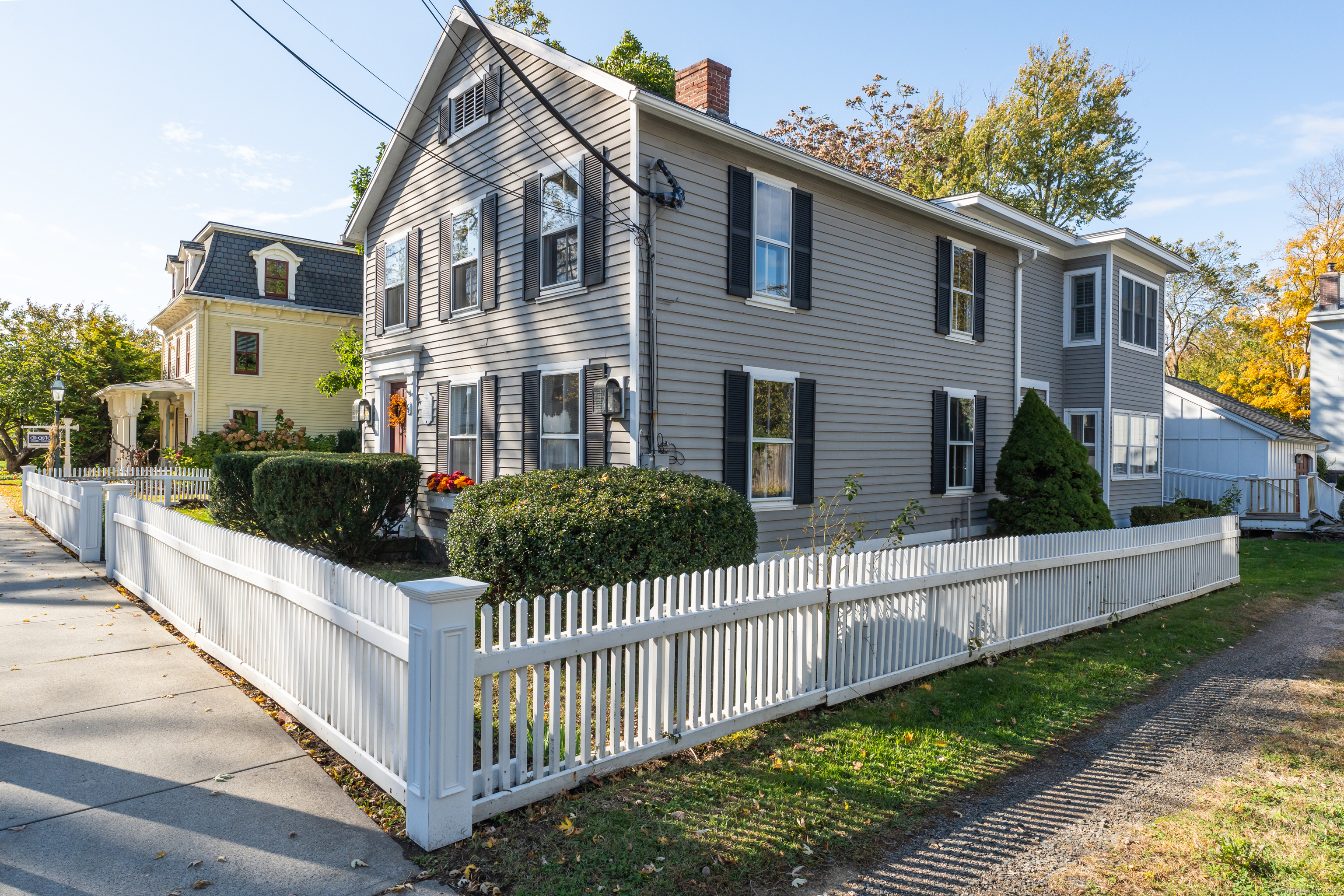 a front view of a house with wooden fence